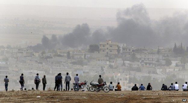 Civilians watch the fighting in Kobane from the safety of the Turkish side of the border, 11 October