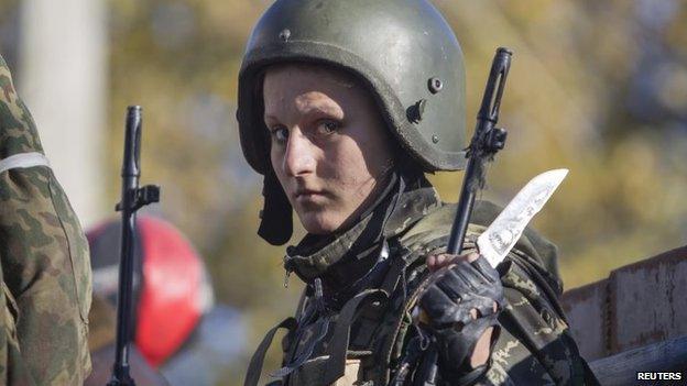 A female pro-Russian rebel stands on a truck as she gets ready to take position near the Sergey Prokofiev International Airport during fighting with Ukrainian government forces in the town of Donetsk, eastern Ukraine, 4 October 2014