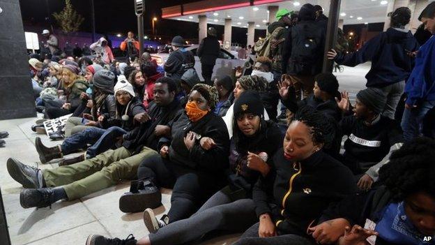 About 50 protesters seeking justice for the Michael Brown and Vonderrit D. Myers shootings conduct a brief sit-in at a QuikTrip, St Louis, 12 October 2014