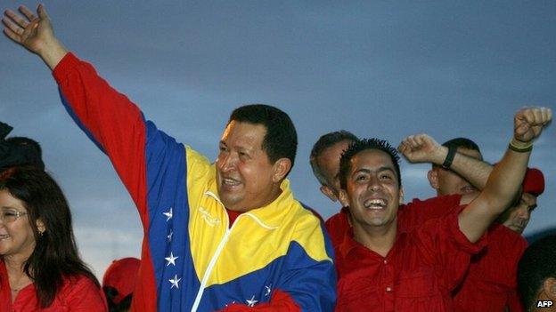 The late Venezuelan President Hugo Chavez (left) and Robert Serra greet supporters during a rally in Caracas on 30 August, 2010