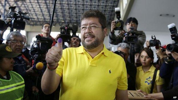 Samuel Doria Medina shows his finger after casting his ballot at a polling station in La Paz on 12 October 2014