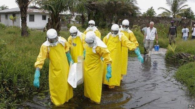 File photo: A burial squad carry the body of an Ebola victim in Marshall, Margini county, Liberia, 25 September 2014