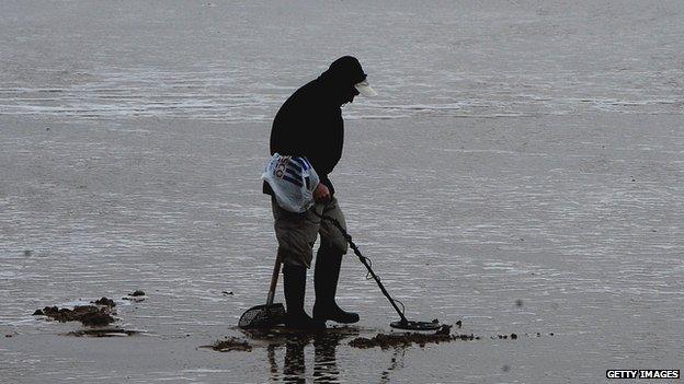 Metal detecting on a beach