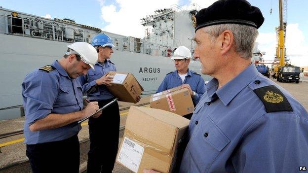 Undated picture issued by MoD showing RFA Argus's Chief Officer Shane Wood (left) checking the first load of supplies for its deployment to Sierra Leone