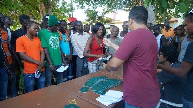 Migrants receive work permits at Rio Branco (October 2014)