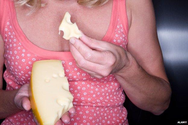 Woman eating cheese