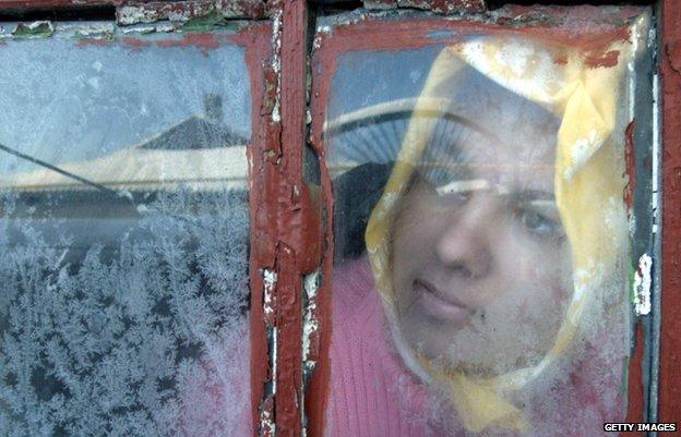 A girl in Donetsk looks through a window as gas supplies are suspended by Russia (Jan 2009)