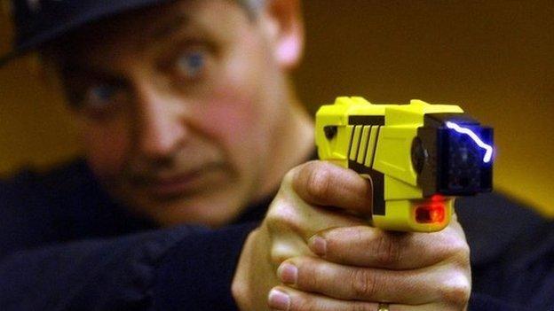 Policeman holding a Taser