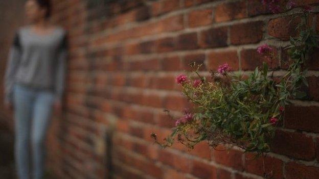 Generic shot of a girl leaning against a wall