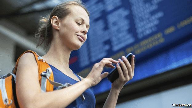 Woman at a station with a phone