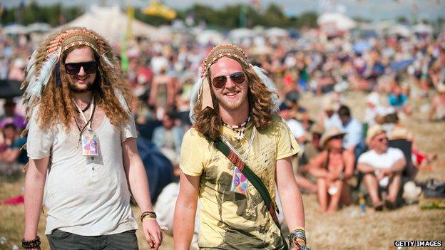 Two festival goers wearing headdresses