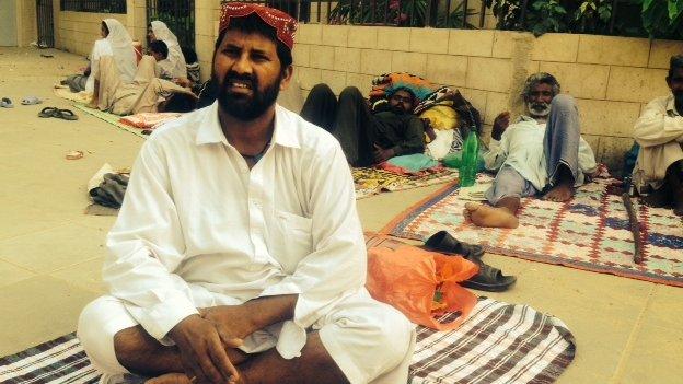 Patients waiting outside a hospital in Pakistan