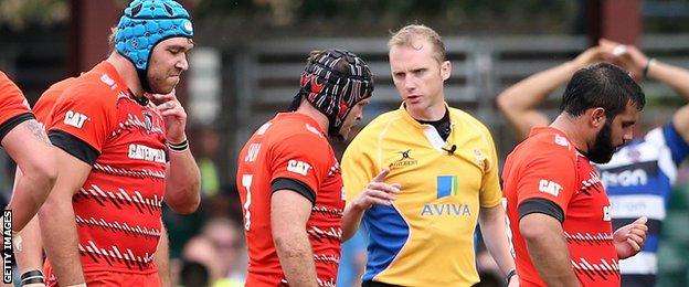 Defeated Leicester players walk off after their hammering at Bath