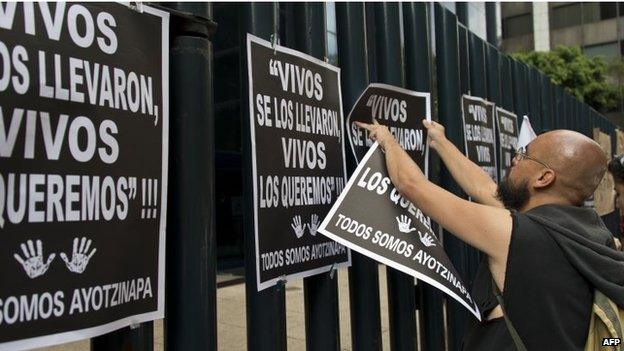 A student hangs posters at the fence of the Attorney General's Office on 15 October, 2014