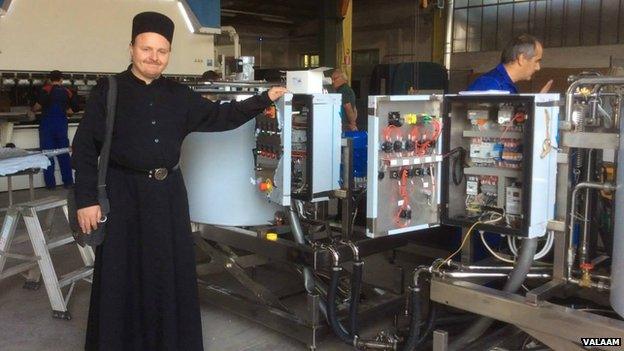 Monk at a cheese factory