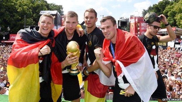 German football players holding trophy