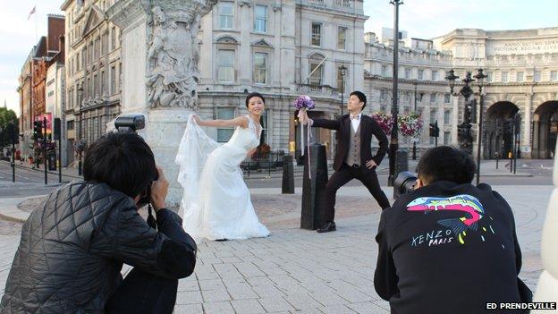 Couple by Admiralty Arch being photographed