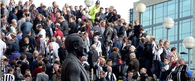 Home fans wait outside St James' Park