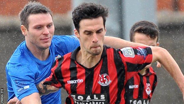 Glenavon's Kevin Braniff in action against Declan Caddell of Crusaders