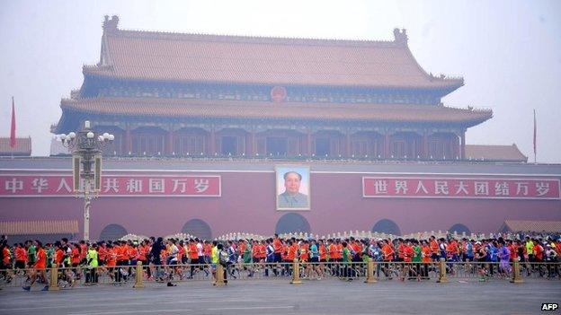 Runners take part in the 34th Beijing International Marathon which began at Tiananmen Square (19th October 2014)