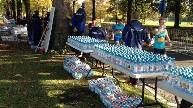 Runners at the water station on the three-mile mark