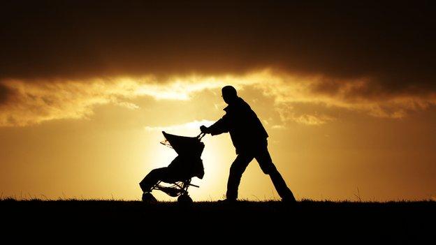 Father pushing child in a pushchair