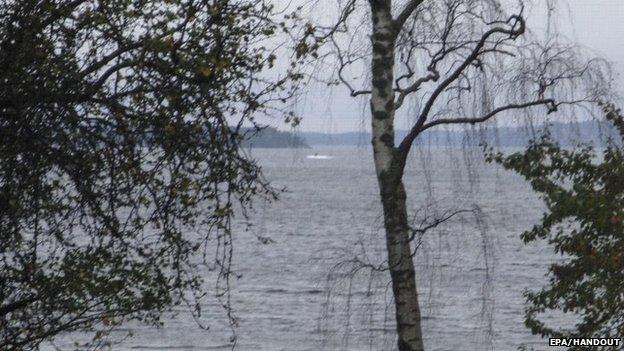 Amateur photo made available on October 19, 2014 by the Swedish Defence Ministry shows an object (top C) in the sea near Stockholm