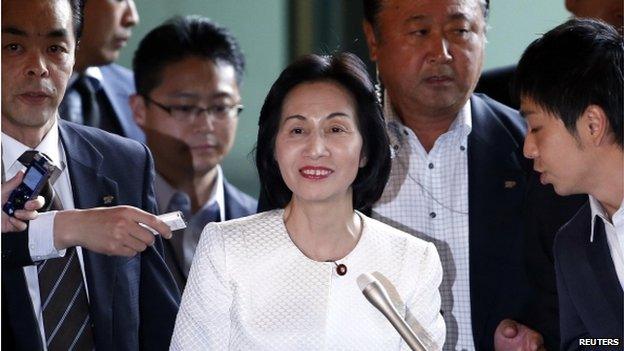 Japan's Justice Minister Midori Matsushima (C) reacts as she is surrounded by reporters upon her arrival at Prime Minister Shinzo Abe's official residence for a meeting with Abe in Tokyo 20 October 2014