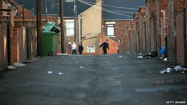 Children playing on a run-down street