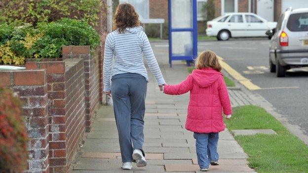 A mother walks with her daughter