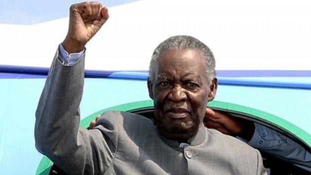 Zambian President Michael Sata gestures upon arrival at Solwezi airport before addressing supporters at an election campaign meeting on 10 September 2014