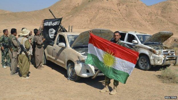 Peshmerga fighters with captured IS vehicles near Tikrit, Iraq - 8 October