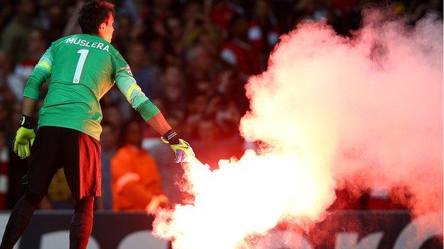 Fernando Muslera of Galatasaray clears a flare