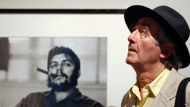 Swiss photographer Rene Burri poses in front of his most famous photo of Che Guevara in Lausanne, Switzerland on 24 June 2004