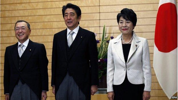 Japan's Prime Minister Shinzo Abe (C) poses for the media with new Economy, Trade and Industry Minister Yoichi Miyazawa (L) and new Justice Minister Yoko Kamikawa at Abe's official residence in Tokyo, Japan, 21 October 2014