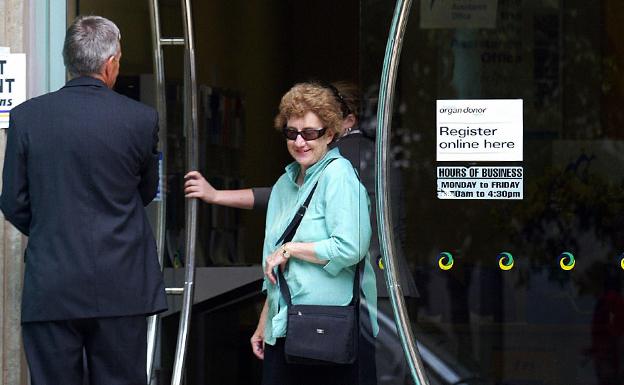 Woman leaving a medicare building, Sydney, 2004