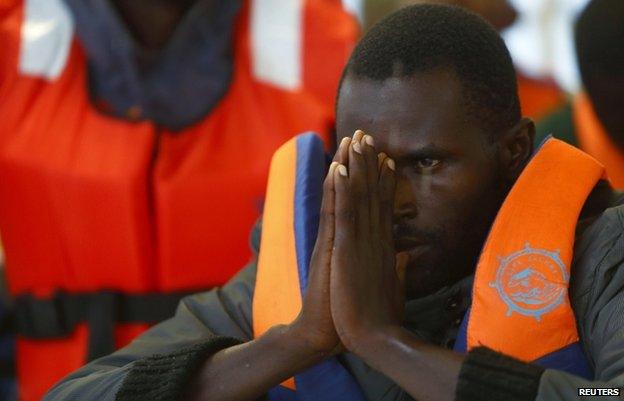 A sub-Saharan migrant arrives on a ship in Pozzallo, Sicily (5 Oct 2014)