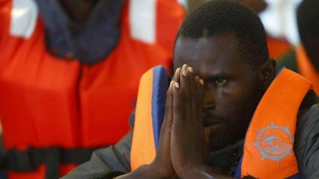 A sub-Saharan migrant arrives on a ship in Pozzallo, Sicily (5 Oct 2014)