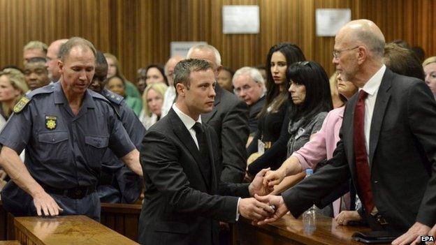 Oscar Pistorius and his uncle Arnold Pistorius at the high court in Pretoria, South Africa on 21 October 2014