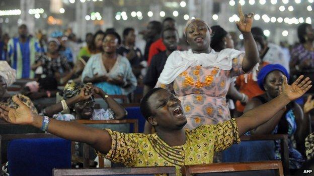 Worshippers pray into the New Year during the crossover watch night church service at the Redemption Camp on Lagos Ibadan highway on 1 January 2014
