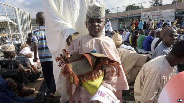 A young Muslim arrives to take part in Eid Al-Adha prayer at the Syrian Mosque in Lagos on 4 October 2014