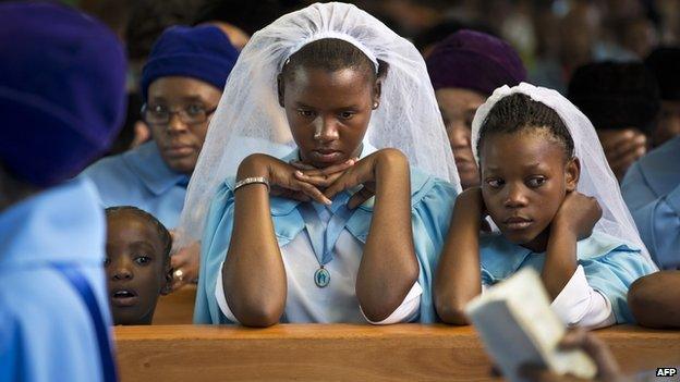 Girls attend a mass in Soweto, South Africa on 8 December 2013