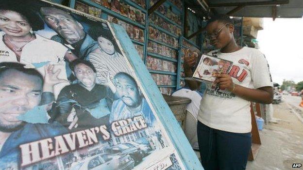 Ivorians look at CDs and DVDs of Nollywood films in a street store in Abidjan, 16 June 2007