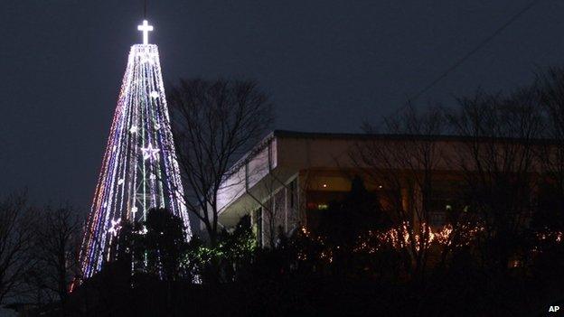 This Tuesday, 21 Dec 2010 photo shows a giant steel Christmas tree lit up at the western mountain peak known as Aegibong in Gimpo, South Korea