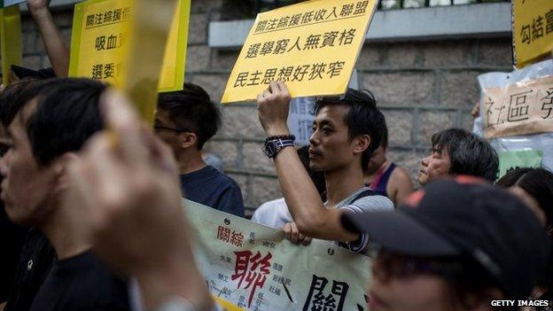 Pro-democracy protesters stand outside Government House after a march from the Admiralty protest site in Hong Kong, 22 October 2014