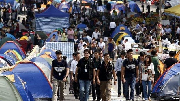 Hong Kong policemen patrol as pro-democracy protesters rally at the ongoing Occupy Central protest movement in the Admiralty District of Hong Kong, China, 22 October 2014