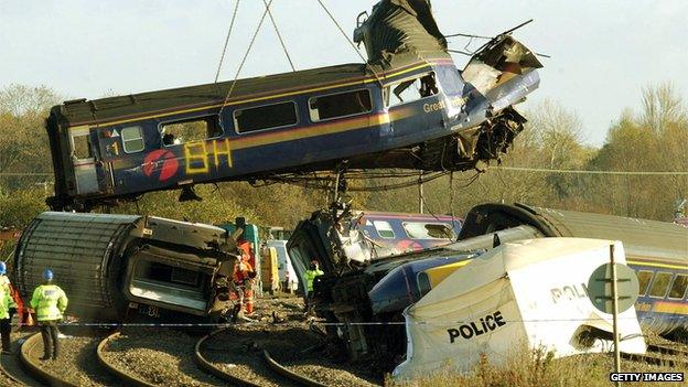 One of the carriages is removed from the track by a crane