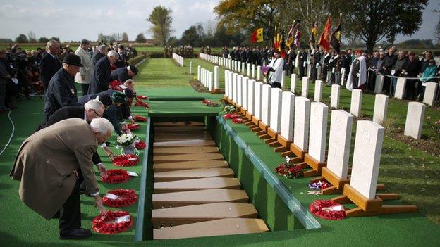 Descendants of the soldiers lay wreaths during the reburial ceremony near Lille