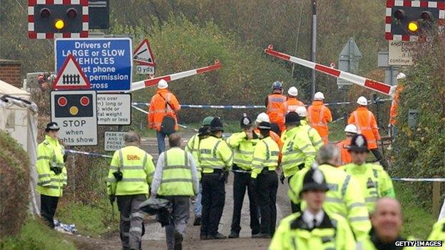 Police and rail workers at the Ufton Nervet level crossing after the crash