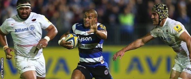 Jonathan Joseph bursts between Saracens forwards James Johnston and Kelly Brown